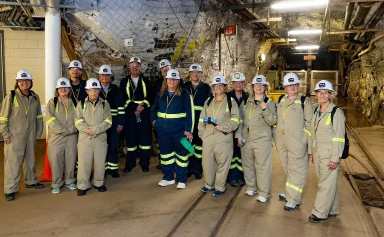 A group of people in PPE and overalls at the 4850 level of SURF. 