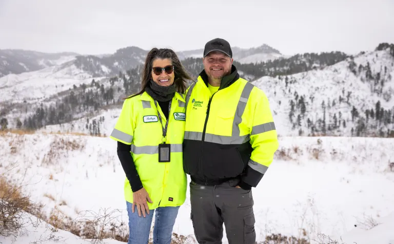 Dan Pierce & Robyn Varland pose outside in the winter of 2025