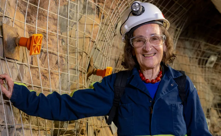 Dr. Neta Bahcall, the Eugene Higgins Professor of Astrophysics at Princeton University shown here underground on the 4850 Level of SURF. 
