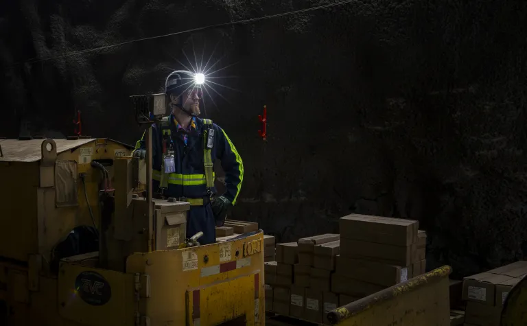  Dr. Douglas Tiedt, SURF research scientist, running a locomotive on the 4850 Level of SURF.    