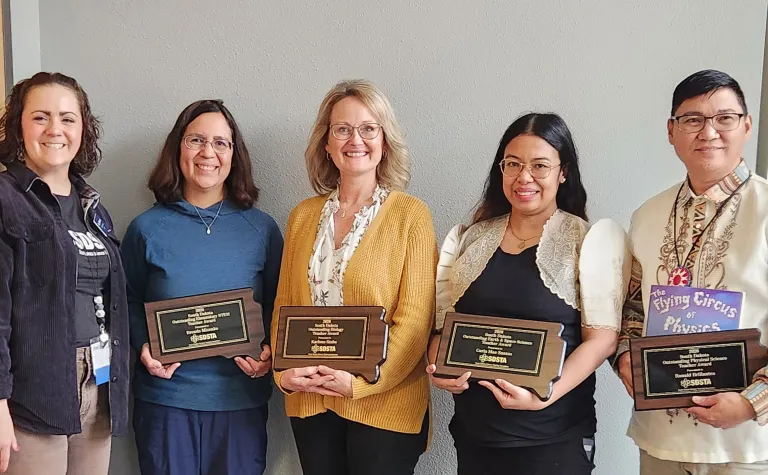 The 2026 Outstanding STEM education teachers in South Dakota holding their awards in a group photo