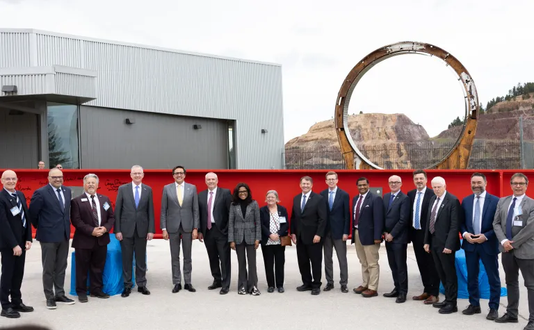Dignitaries and officials celebrate a major milestone for the Deep Underground Neutrino Experiment on May 7. The event marked the start of 10 million pounds of steel beams being lowered underground to form the DUNE detectors. Photo credit: Landin Burke, 605 Media & Entertainment.