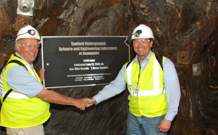 T Denny Sanford and Mike Rounds shake hands at Governor's corner in 2009
