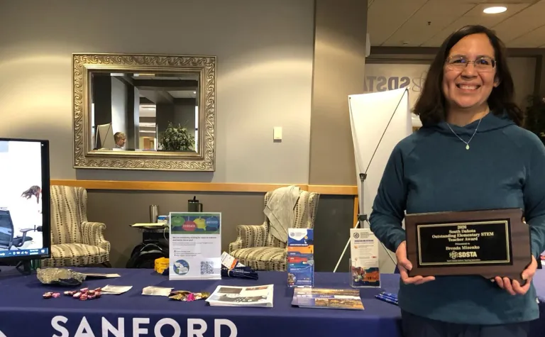 Brenda Mizenko of St. Elizabeth Seton Elementary School in Rapid City holding her award at the SURF booth for the 2026 STEM Ed Conference 