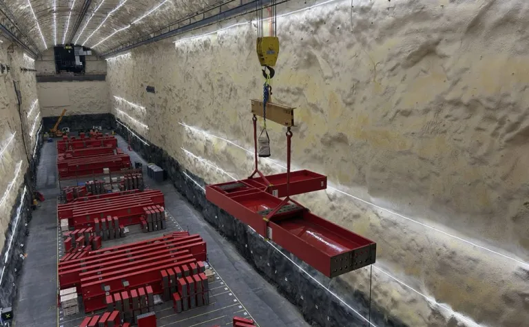 An L-beam for a DUNE cryostat is moved in the south cavern, which is nearly a mile below the surface at the Sanford Underground Research Facility. The research space, more than 500 feet long and about seven stories tall, will house one of the experiment’s massive detector modules. 
