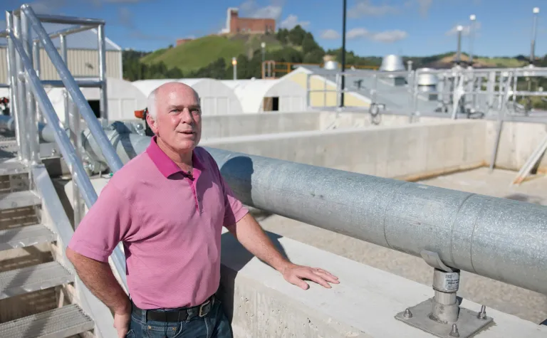 Todd Hubbard speaks with his hand on the pool for MMBR at the WWTP at SURF. 