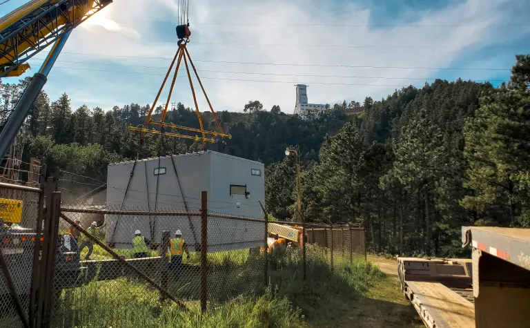 crane lowers the prefabricated E-House