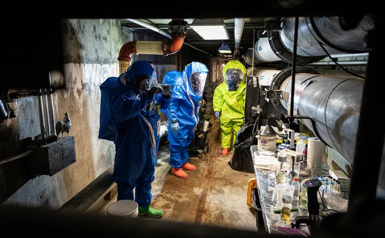 Sgt. Travis Johnson, left, and Sgt. Domonic Delaney, both of the 81st Civil Support Team, assisted by the Rapid City Fire Department Hazardous Materials (HAZMAT) team, take samples of biological agents during a chemical and biological weapons response exercise at the Sanford Underground Research Facility (SURF) in Lead, South Dakota, April 26, 2022. 