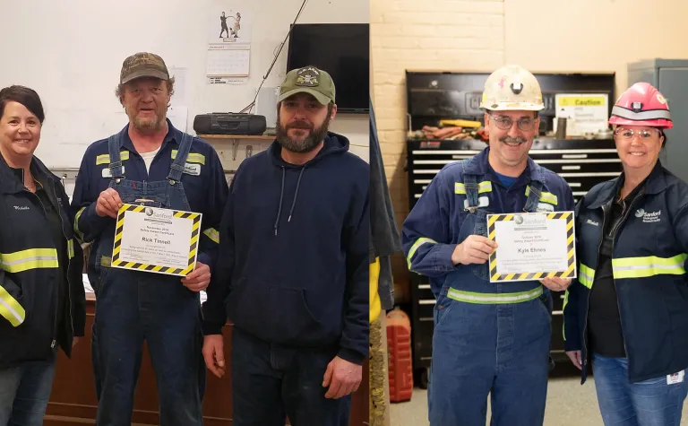 Members of the safety committee recognize employees with safety performance awards.
