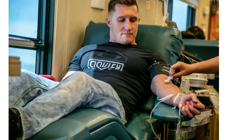 Man in chair gets ready to give blood