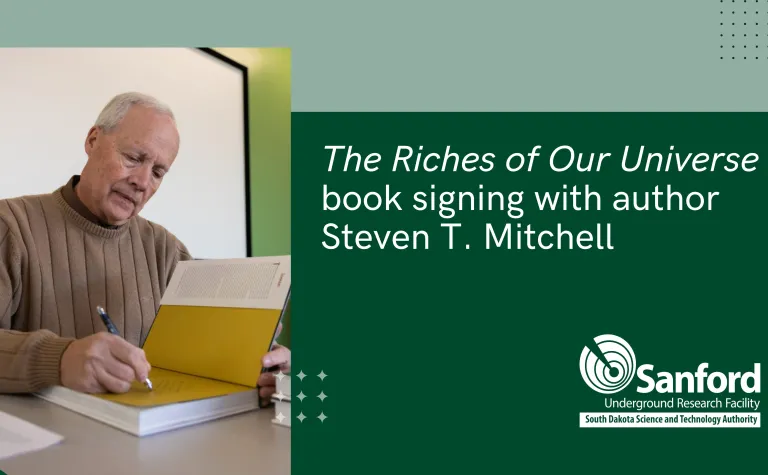 Steven T. Mitchell signing a copy of his new book 