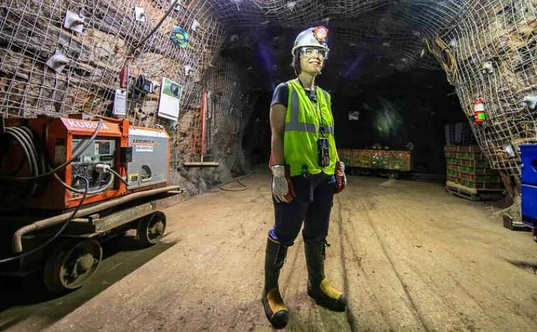 Gina Gibson stands in the middle of an underground drift 