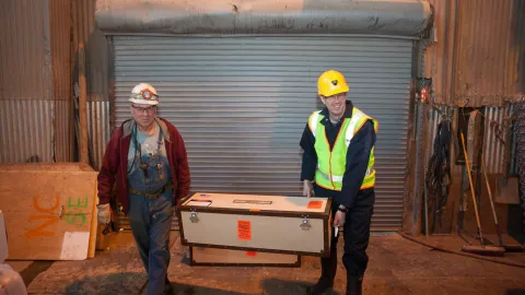 Technicians at work getting items ready to go underground.