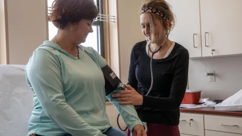 nurse taking a lady's blood pressure