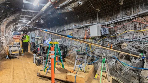 scientists working underground with a bore hole