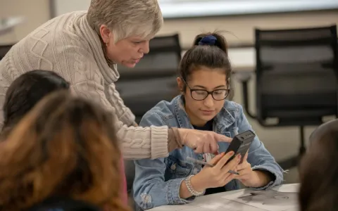 lady helping a young girl in a classroom