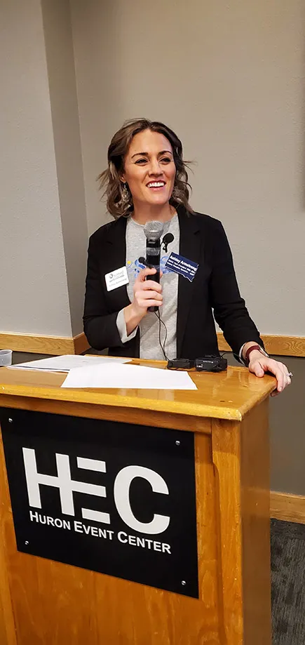 Dr. Ashley Armstrong addresses the SD STEM ED Conference from a podium.