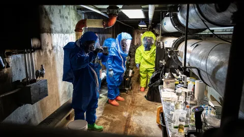 emergency response team in hazmat suits in an underground confined space