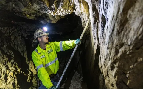 Infrastructure technician works in drift to remove rock