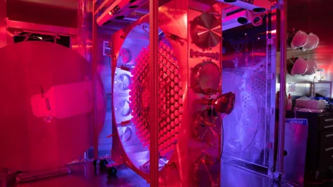 the phtoto multiplier array for LZ on its side in some red and purple lighting in a high-tech environemnt 