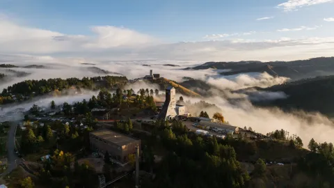 Aerial photo of the foggy black hills. Ross and yates headframes are in the shot. 
