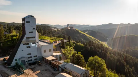 aerial photo of the ross headframe in the foreground and the yates in the background