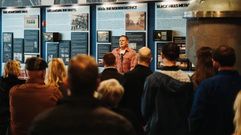 will mcelroy speaks to a crowd in the visitor center