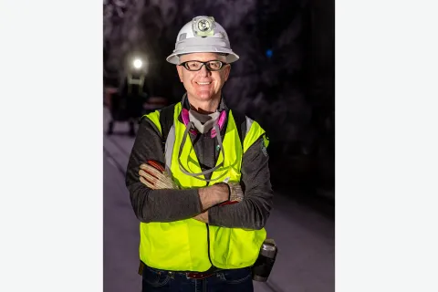 Mike Headley at the 4850L in full PPE including a reflective vest, gloves, safety glasses, a hard hat, and a resperator around his neck.