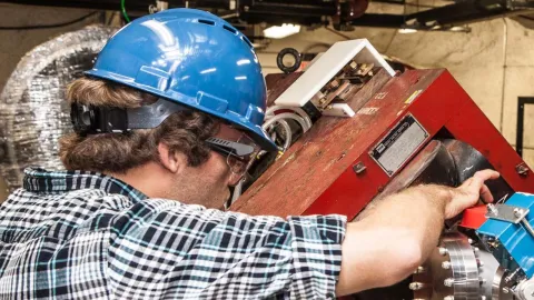 person works on accelerator section