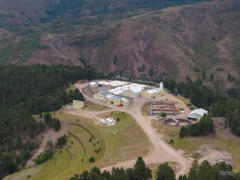An image from above the SURF waster water treatment plant showing the facility, the gravel road, and the surrounding hills.