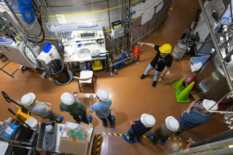 a shot from above showing individuals in hard hats and PPE viewing the LZ experiment 
