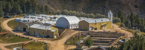 Waste Water Treatment Plant. Some yellow colored buildings and a large hoop building. 