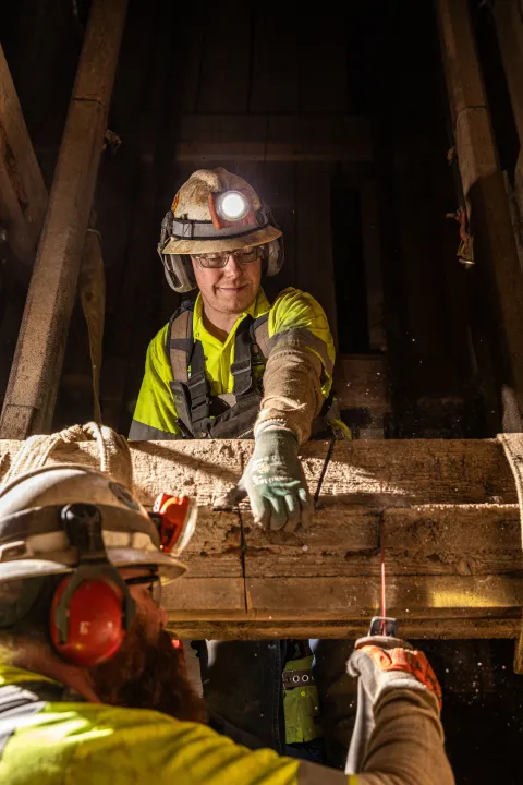 Crews cut an old timber inside the Yates Shaft