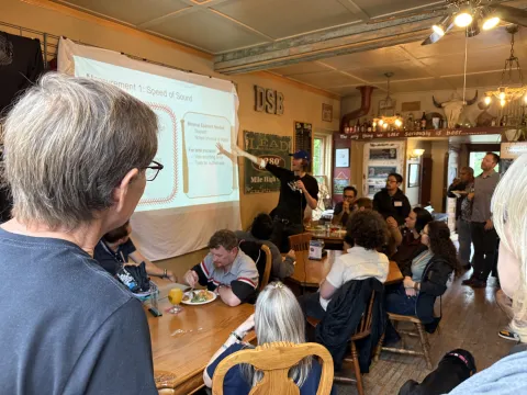 Individuals taking part in a "Pub Talk" who are gathered in Lead.