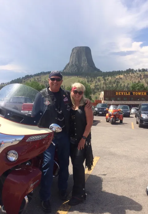 Two people with a motorcycle at Devils Tower