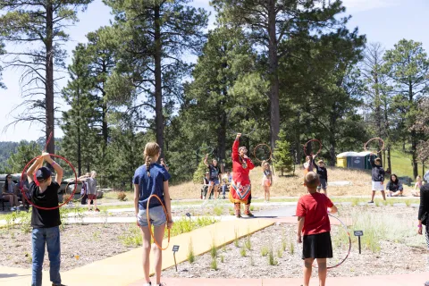 A group learns to hoop dance
