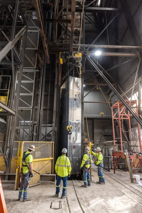 A sling load of a piece of scientific equipment at the top of the Ross Shaft at SURF.
