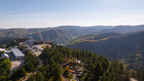 D drone show above the Yates Campus at SURF showing the headframe, Hoistroom, Rounds Operation Center and Čhaŋgléška Wakȟáŋ in the fall colors..