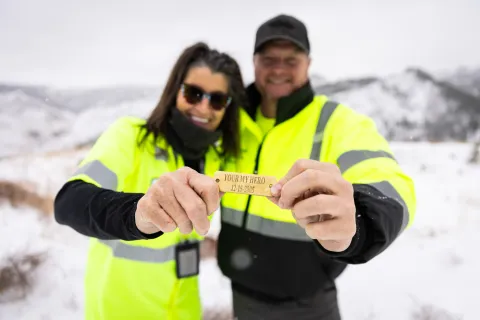 Dan Pierce and Robyn Varland show off a brass tag Robyn made