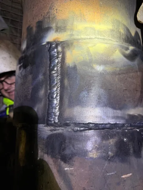 A gorgeous weld on a pipe inside the Ross Shaft with King Brown, Pipe welder in the background. 