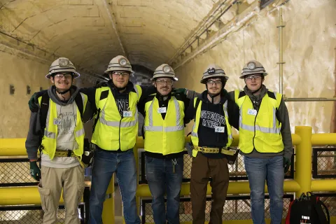 A group posed inside the DUNE Cavern