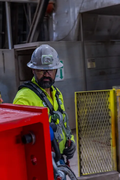 Technicians prep one fo the DUNE cryostat beams for loading into the cage