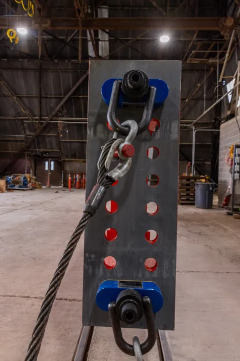 Technicians prep one of the DUNE cryostat beams for loading into the cage--this shows the rigging set up on the beam.