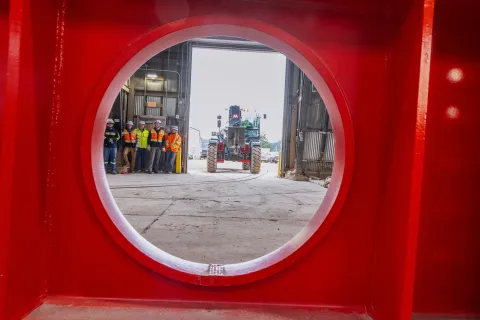Technicians prep a the DUNE cryostat beams for loading into the cage.