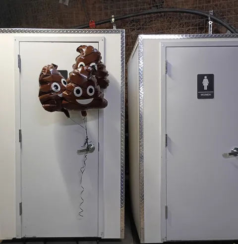 Balloons on a bathroom door in an opening celebration 