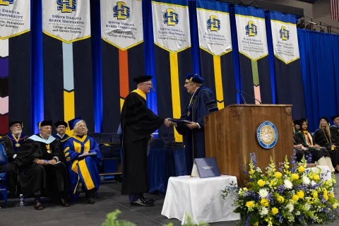 Mike Headley receiving an honorary doctorate from SDSU. 