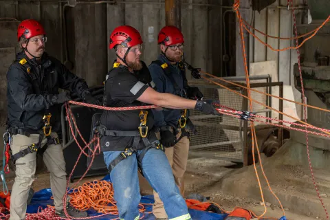 SURF ERT Members assist William Buckman from NIM Medical completing a mock rope rescue at SURF.