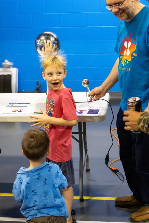 Kids work on a hands-on science demonstration at Neutrino Day
