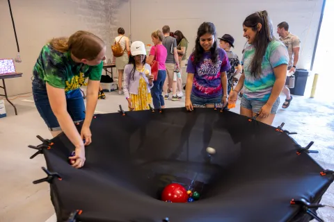 Kids work on a hands-on science demonstration at Neutrino Day