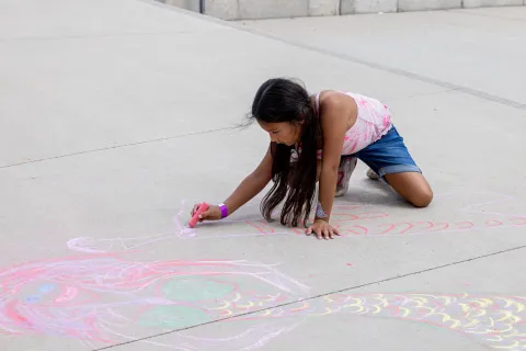 Kids make chalk art on Neutrino Day  